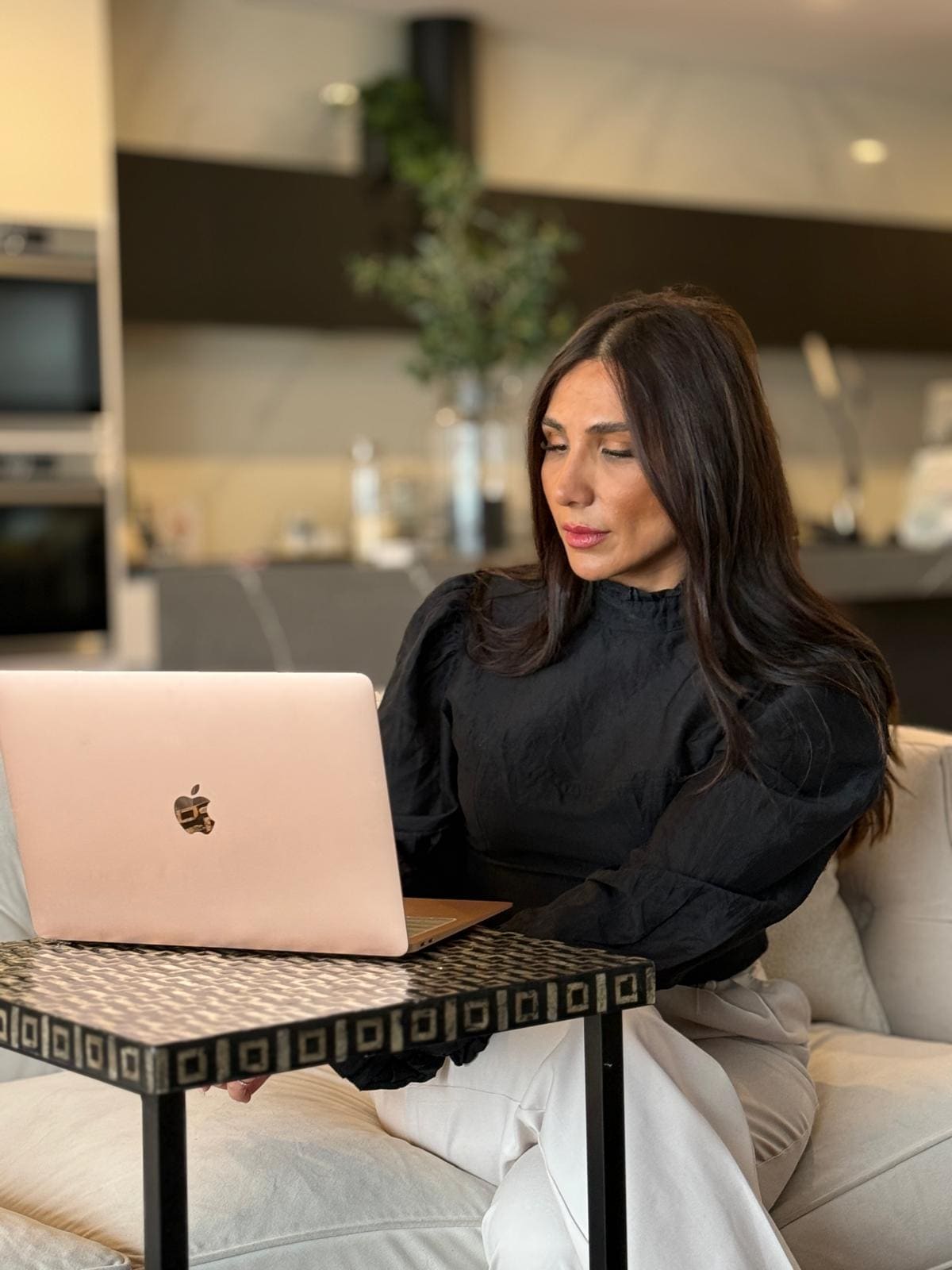 Mona working on her laptop